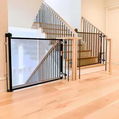 Two black retractable gates installed at the top and bottom of staircase.