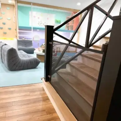 Black retractable gate installed at the bottom of staircase