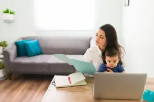 Blog 1 Mom with baby working on the computer in their living room